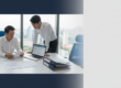 Asian business professional reviews documents in modern office, Singapore skyline blurred in background.
